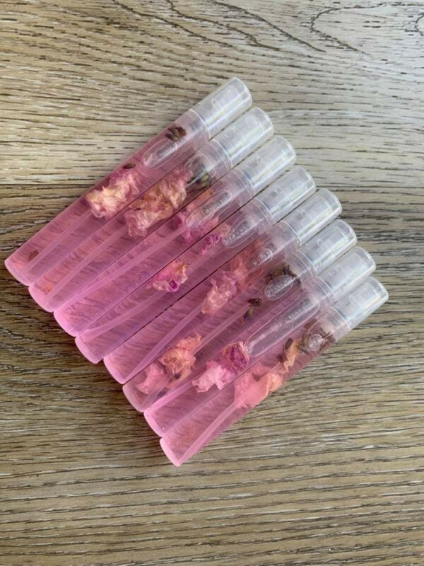 Pink perfume bottles with dried flowers.