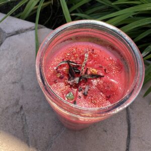 A glass of smoothie sitting on the ground.