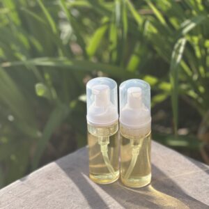 Two bottles of lotion sitting on a table.