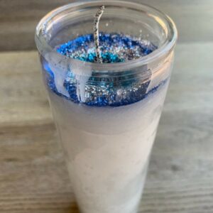 White candle with blue glitter top.