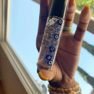 Glitter roller bottle with evil eye charms.