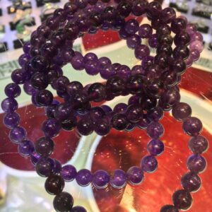 Purple amethyst beaded bracelets on display.