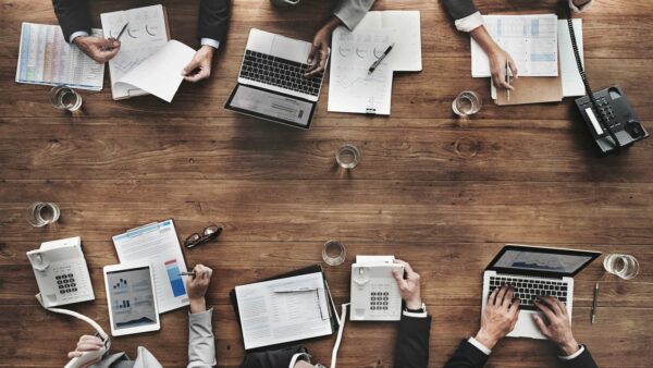 Business people working on a wooden table.