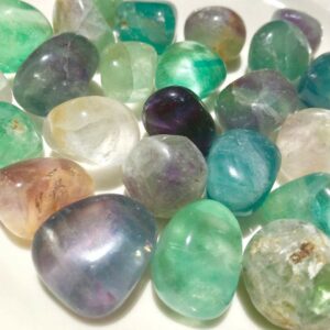 A collection of colorful fluorite tumbled stones.