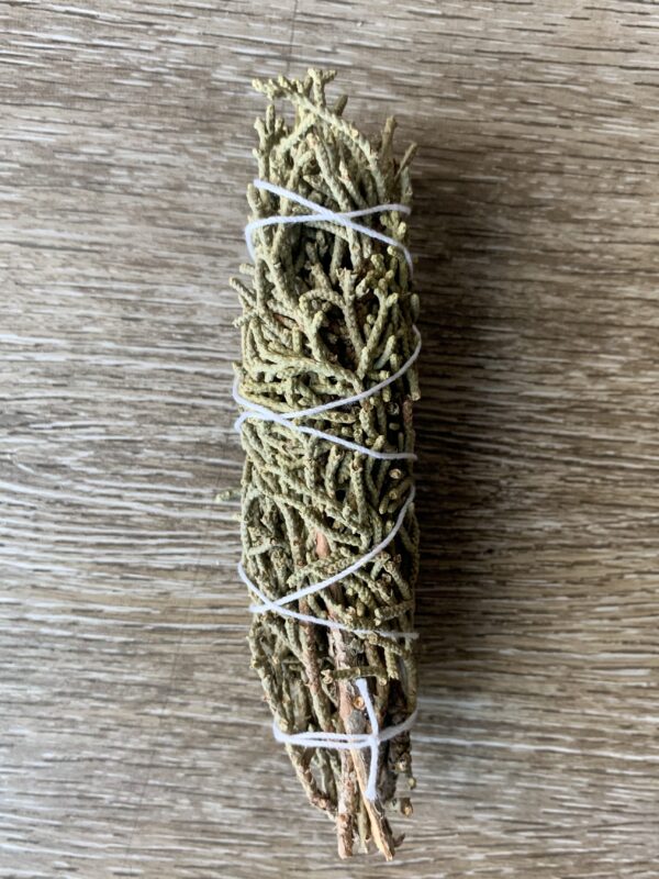 White sage smudge stick on wood.