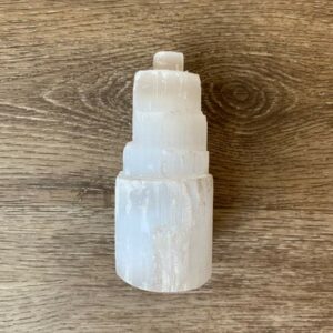 White selenite crystal tower on wood