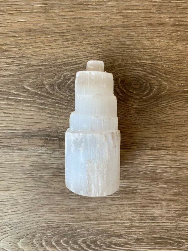 White selenite crystal tower on wood