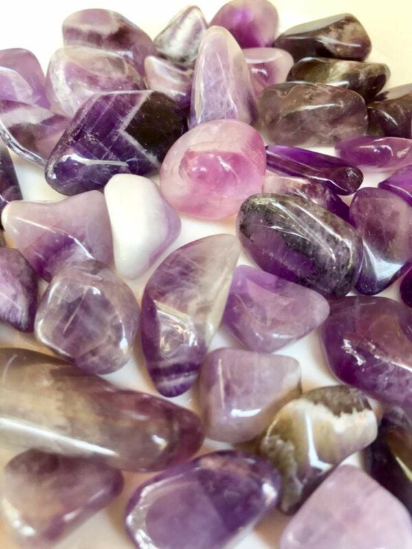 Purple and white amethyst tumbled stones.