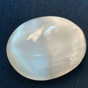 White selenite crystal on a dark background.