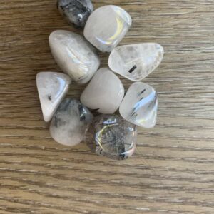 Collection of tumbled black tourmaline quartz crystals.