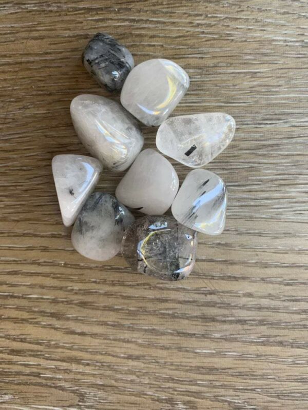 Collection of tumbled black tourmaline quartz crystals.