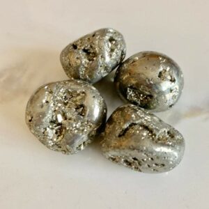 Four smooth, silver pyrite stones.