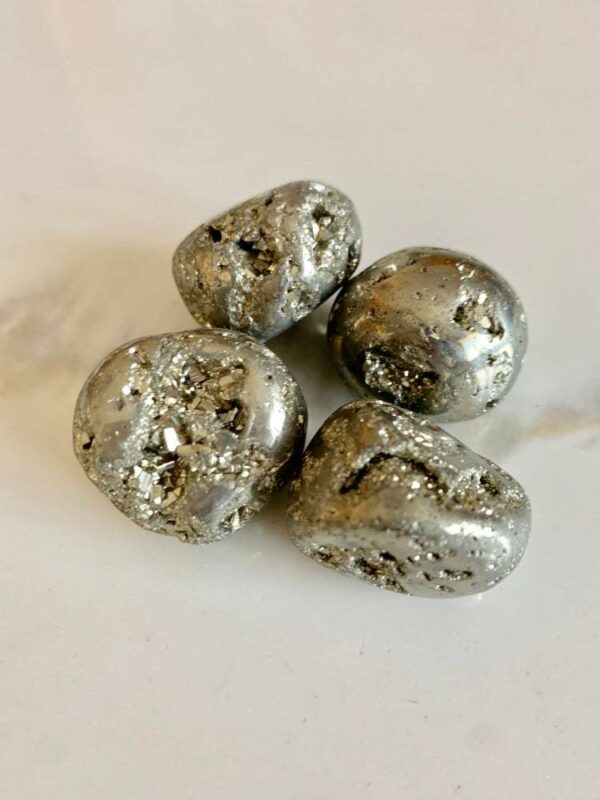 Four smooth, silver pyrite stones.