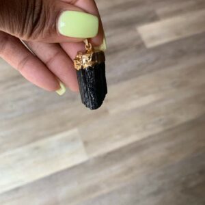 Black tourmaline pendant with gold accents.