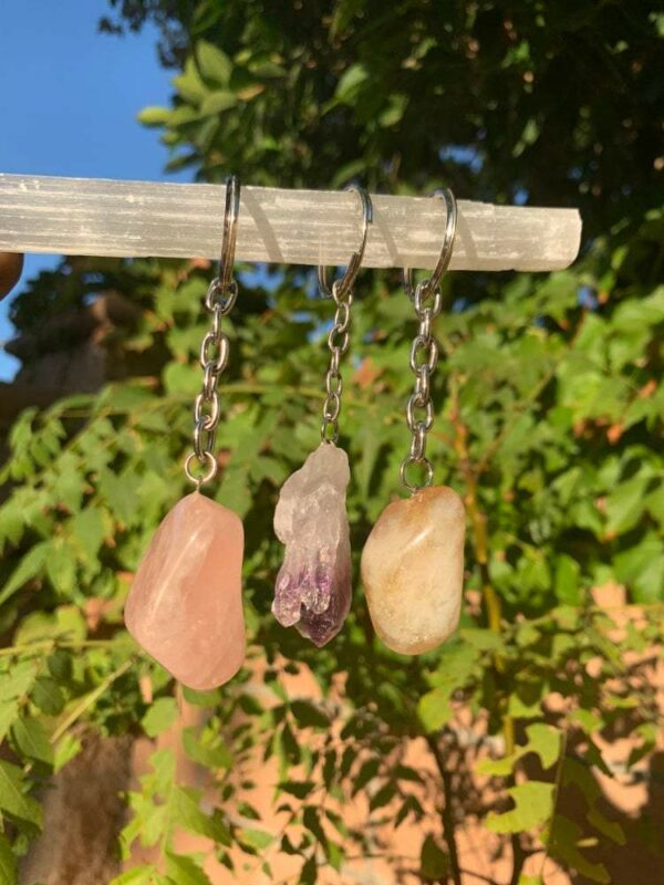 Three crystal stone keychains on display.