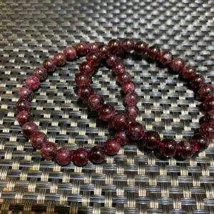 Two red gemstone beaded bracelets.