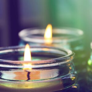 Close-up of lit candles in jars.