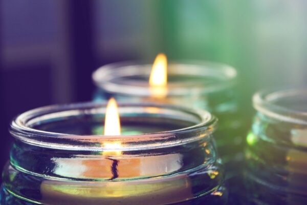 Close-up of lit candles in jars.