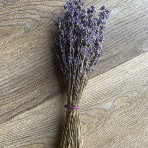 Bundle of dried lavender on wood.