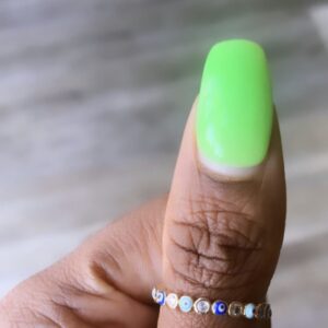 Hand with green nail polish and evil eye ring.