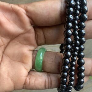 Black hematite bead bracelet on a hand.