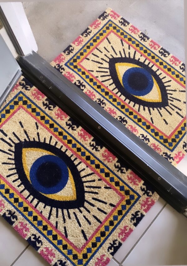 Doormat with colorful evil eye design.