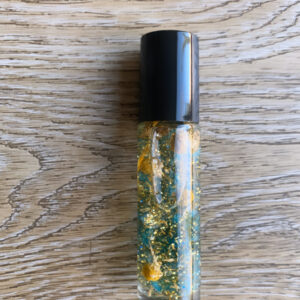 Gold glitter oil roller bottle.