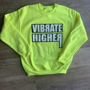 Yellow sweatshirt with "Vibrate Higher" text.