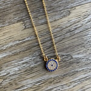 Gold chain with blue evil eye pendant.