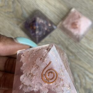 Pink crystal pyramid with gold swirl.