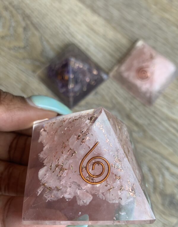 Pink crystal pyramid with gold swirl.