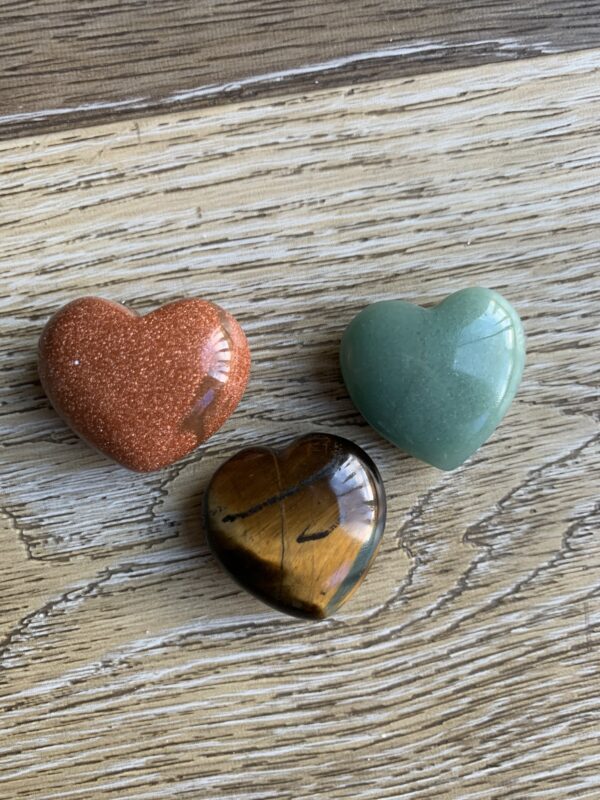 Three heart shaped gemstone crystals.