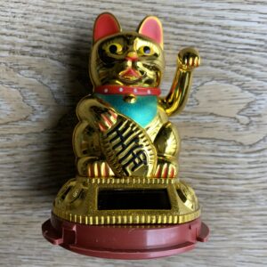 Golden Maneki-Neko lucky cat figurine.