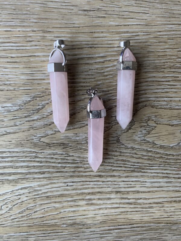 Three pink quartz crystal pendants.