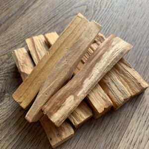 Stack of light brown palo santo sticks.