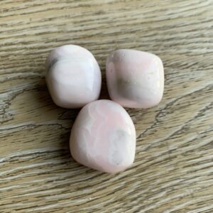 Three pink and white tumbled stones.