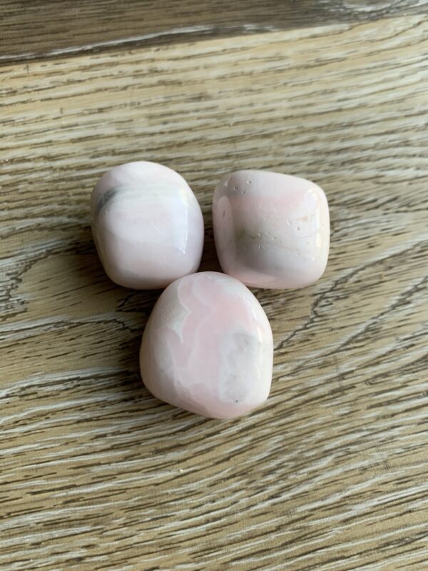 Three pink and white tumbled stones.