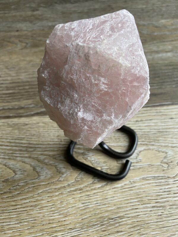 Pink crystal on a black stand.