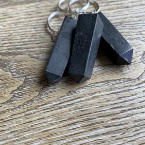 Three black crystal point keychains.