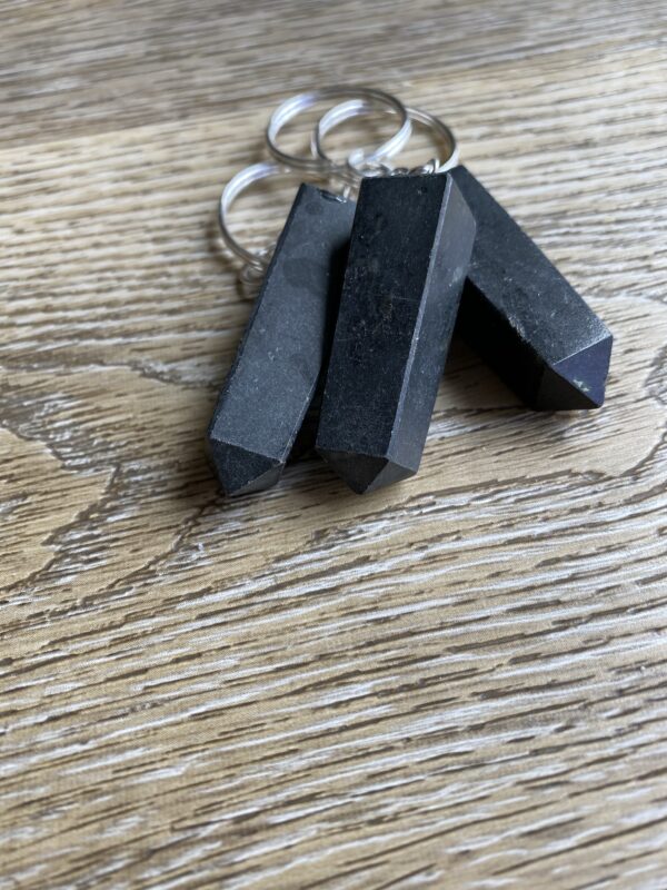 Three black crystal point keychains.