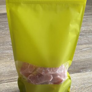 Yellow bag of pink Himalayan salt crystals.