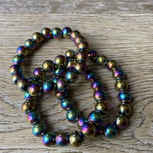 Rainbow iridescent beaded bracelet on wood.