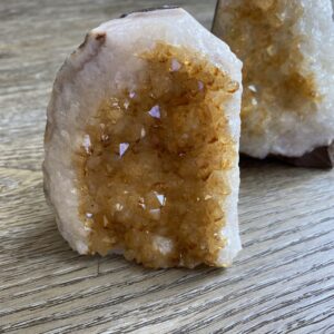 Citrine crystal cluster on wooden surface.