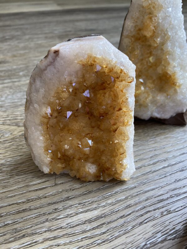 Citrine crystal cluster on wooden surface.