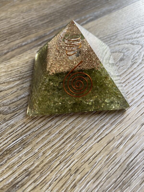 Green crystal pyramid with copper coil.