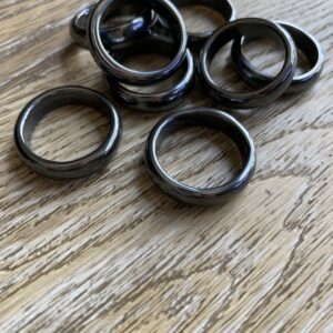 Black hematite rings on wood table.