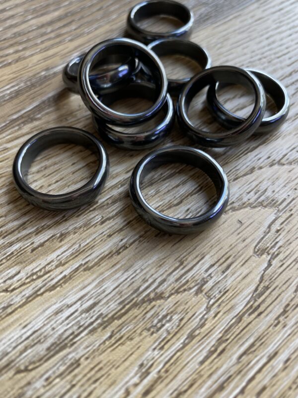 Black hematite rings on wood table.