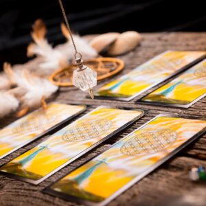 Tarot cards and a crystal pendulum.