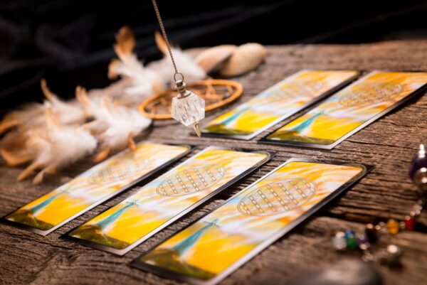 Tarot cards and a crystal pendulum.