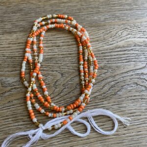 Orange, white, and gold beaded necklace.